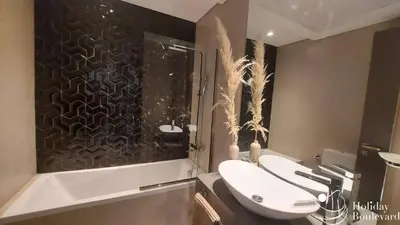 a bathroom with a toilet and a sink and a shower at Stylish 1br Brand New Prime Business Bay Stay in Dubai