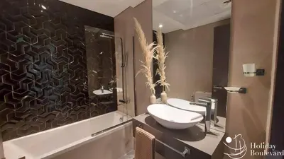 a bathroom with a toilet and a sink and a shower at Stylish 1br Brand New Prime Business Bay Stay in Dubai