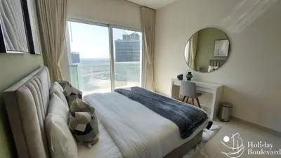 a bedroom with a bed and a mirror and a window at Stylish 1br Brand New Prime Business Bay Stay in Dubai