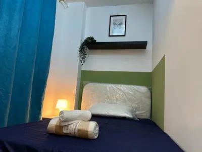 a bed with two pillows on top of it at Enchanted Stay Partition Room in Barsha Heights in Tecom in Dubai