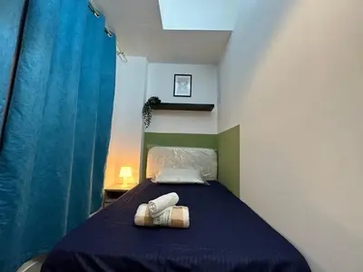 a bedroom with a bed with two towels on it at Enchanted Stay Partition Room in Barsha Heights in Tecom in Dubai