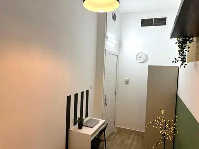 a small room with a desk and a door at Passion Nest Room in Barsha Heights Tecom in Dubai