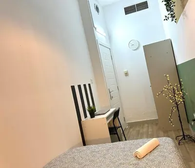 a small room with a table and a mirror at Passion Nest Room in Barsha Heights Tecom in Dubai