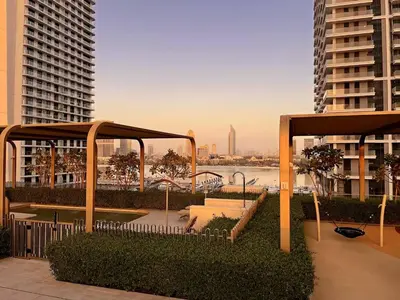 a patio with a view of the water and buildings at Luxury Oasis | Private Beach & Infinity Pool in Dubai