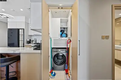 a kitchen with a washer and dryer in a closet at 2BR Burj Khalifa Dubai Mall View in Dubai