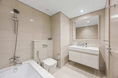 a bathroom with a tub and a toilet and a sink at 2BR Burj Khalifa Dubai Mall View in Dubai