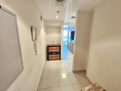 a hallway with a sink and a dresser in a room at Cricket Tower in Dubai