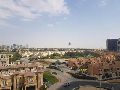 arial view of a city with buildings and a street at Cricket Tower in Dubai