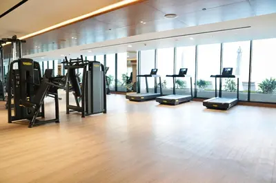 a gym with treadmills and ellipticals in a building at Spacious 1BR Balcony Jacuzzi in Dubai