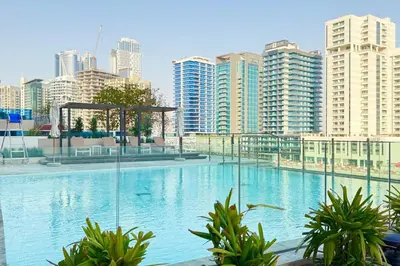 a large swimming pool in a city with tall buildings at Jacuzzi Canal view BusinessBay in Dubai