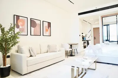 a white living room with a white couch and a table at Jacuzzi Canal view BusinessBay in Dubai