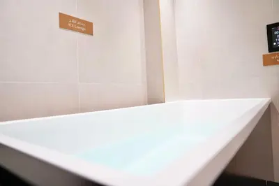 a white counter in a room with a sign on the wall at Canal View Studio Jacuzzi in Dubai
