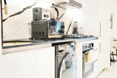 a kitchen with a washer and dryer on a counter at Canal View Studio Jacuzzi in Dubai