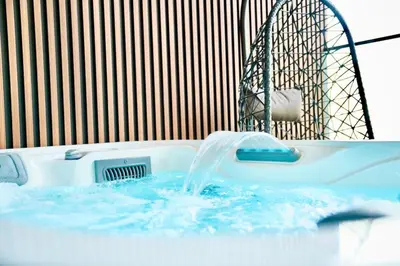 a bath tub with a water fountain in it at Exclusive Jacuzzi Canal View in Dubai