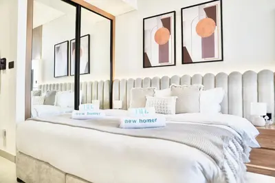 a bedroom with a large bed with two boxes on it at Exclusive Jacuzzi Canal View in Dubai