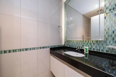 a bathroom with a sink and a mirror at Chic Waterfront 1 Bed with Panoramic Marina Views in Dubai