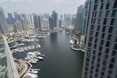 a view of a river with boats in a city at Chic Waterfront 1 Bed with Panoramic Marina Views in Dubai