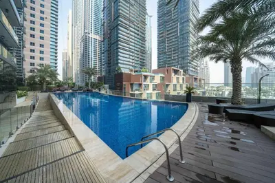 a swimming pool in a city with tall buildings at Chic Waterfront 1 Bed with Panoramic Marina Views in Dubai