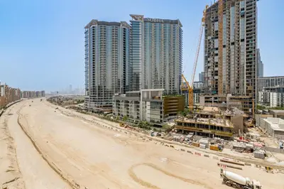an empty beach in front of some tall buildings at GLOBALSTAY Elegant Meydan Apartments - Azizi Riviera 40 in Dubai