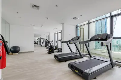 a gym with treadmills and elliptical machines at GLOBALSTAY Elegant Meydan Apartments - Azizi Riviera 40 in Dubai