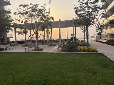 a park with benches and trees in a building at Palm View Marina Vista 1BR Beachfront in Dubai