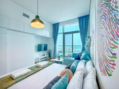 a living room with a large bed and a couch at Minimal Studio in Marina Sea View in Centric & Top Building in Dubai