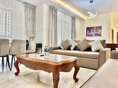 a living room with a couch and a coffee table at Renovated 2bdr in Sadaf 7 JBR in Dubai