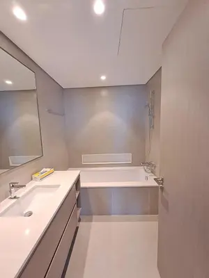 a bathroom with two sinks and a bath tub at Next to Burj Khalifa 5 Mins Walk To Dubai Mall in Dubai