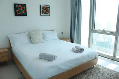 a bedroom with a bed with two stuffed animals on it at Next to Burj Khalifa 5 Mins Walk To Dubai Mall in Dubai