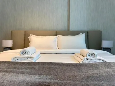 a bedroom with a bed with towels on it at DAYF-POLO Modern 1BR Escape Polo Residences Meydan in Dubai