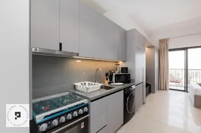 a kitchen with a stove and a counter top at Affordable New Studio I MAG 980 I Summer Deal in Dubai