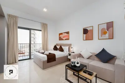 a hotel room with a bed and a couch at Affordable New Studio I MAG 980 I Summer Deal in Dubai