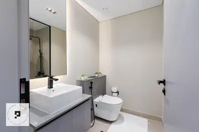 a bathroom with a sink and a toilet and a mirror at Affordable New Studio I MAG 980 I Summer Deal in Dubai