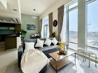 a living room with a couch and a table at Luxury Apt Near Burj & Metro in Dubai