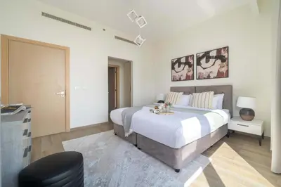 a bedroom with a large bed in a room at Frank Porter - MADA Residences, Downtown in Dubai