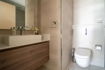 a bathroom with a toilet and a sink and a shower at Frank Porter - MADA Residences, Downtown in Dubai