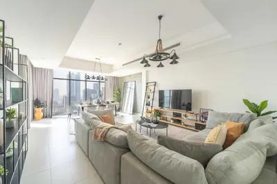 a large living room with a couch and a table at Frank Porter - MADA Residences, Downtown in Dubai
