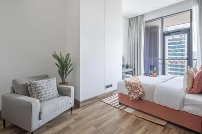 a bedroom with a bed and a chair and a window at Frank Porter - J One Tower, Buisness Bay in Dubai