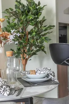 a table with a plate of food and a tree at Frank Porter - J One Tower, Buisness Bay in Dubai