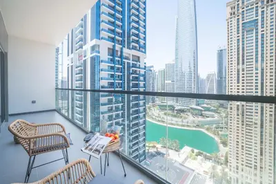 a balcony with two chairs and a view of a city at Frank Poretr - MBL Royal, Jumeirah Lakes Towers in Dubai