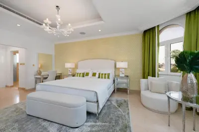 a bedroom with a bed and a couch and a chair at Maison Privee - Ultra-Luxury Villa with Private Pool & Beach on Palm in Dubai