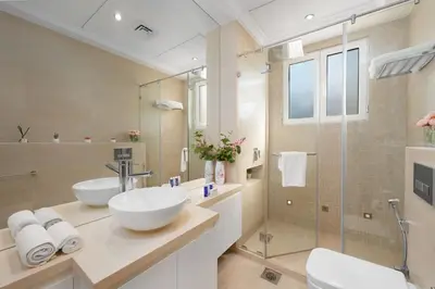 a bathroom with two sinks and a shower at Maison Privee - Ultra-Luxury Villa with Private Pool & Beach on Palm in Dubai