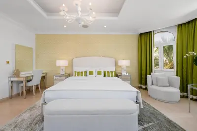 a bedroom with a large white bed and a desk at Maison Privee - Ultra-Luxury Villa with Private Pool & Beach on Palm in Dubai