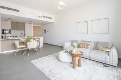 a living room with a couch and a table at Frank Porter - Kensington Waters, Sobha Hartland in Dubai