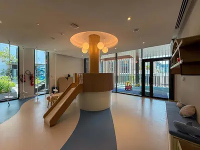 a large living room with a staircase in a house at Frank Porter - Kensington Waters, Sobha Hartland in Dubai