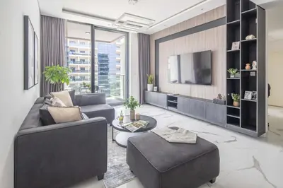 a living room with a couch and a tv at Frank Poretr - The Pinnacle, Dubai Hills in Dubai