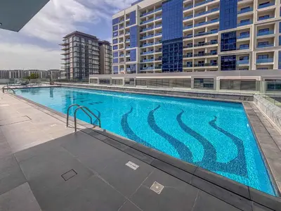 a large swimming pool on the side of a building at Frank Poretr - The Pinnacle, Dubai Hills in Dubai