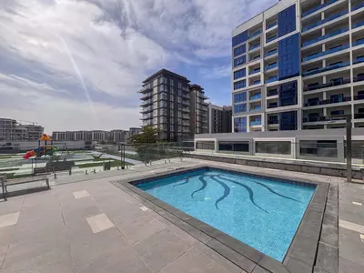 a large swimming pool in front of a building at Frank Poretr - The Pinnacle, Dubai Hills in Dubai