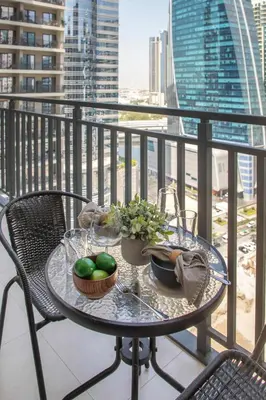 a table on a balcony with a view of a city at Frank Porter - Zada Tower in Dubai