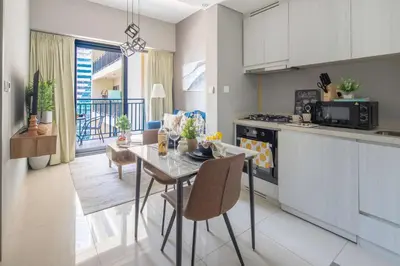 a kitchen and dining room with a table and chairs at Frank Porter - Zada Tower in Dubai